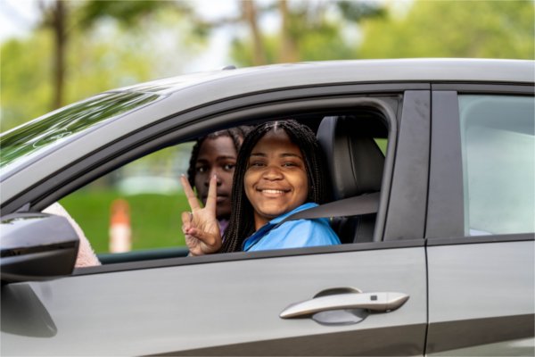 Student Kenndi Dortch smiles alongside a friend while seated in her vehicle during the first day of Valley Campus move-in on August 26.