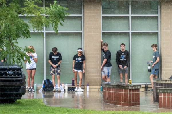 Members of the GVSU Track and Field team seek shelter from a rainstorm during Move-In Day on August 26.