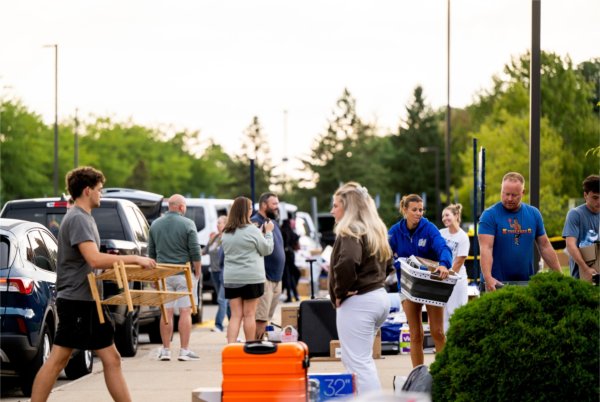 Students and families gather boxes and items before heading into a living center during Move-In Day on August 26. 