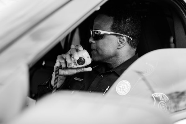 officer in car talking on radio