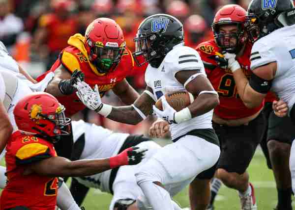 Grand Valley football player evades Ferris State defenders. 
