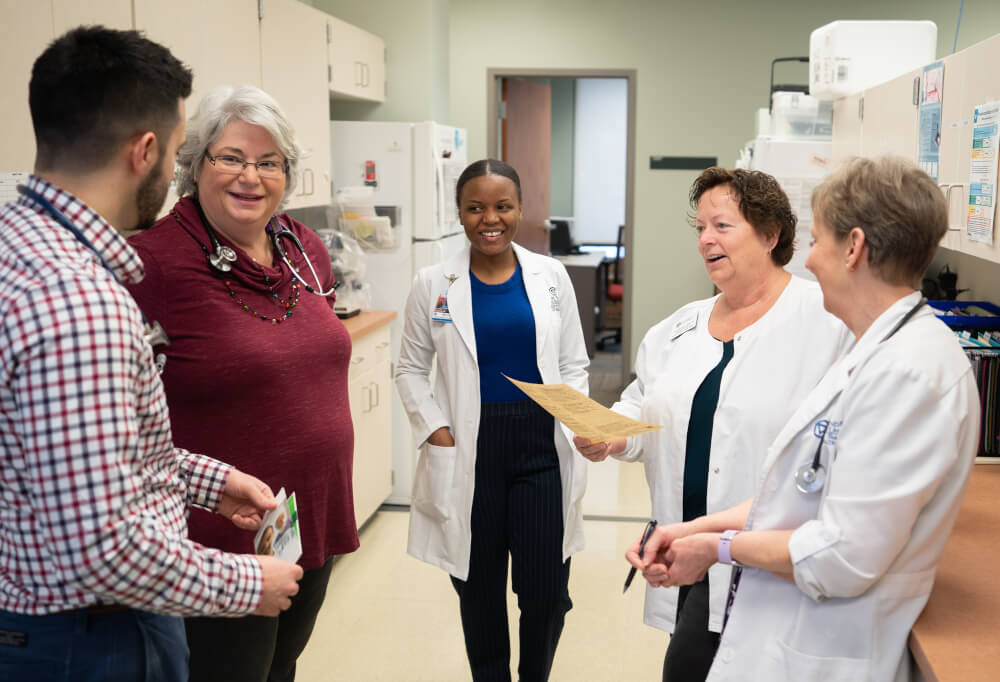 group of nursing staff standing in office suite