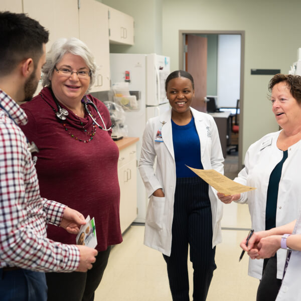 group of nursing staff standing in office suite