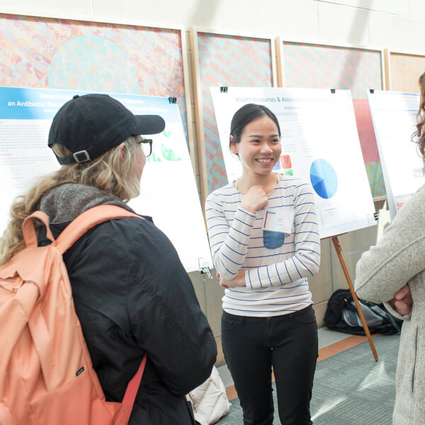 woman giving poster presentation