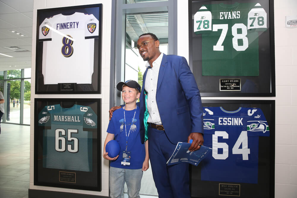 man and young boy in front of jerseys