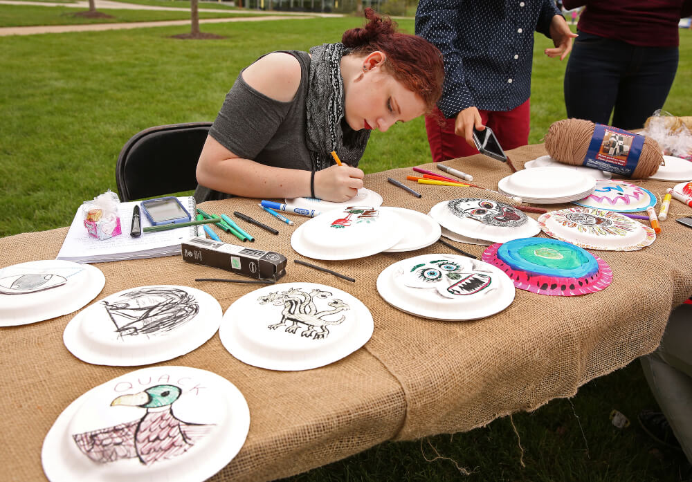Students decorating plates with Egyptian hieroglyphics. Photo by Rex Larsen