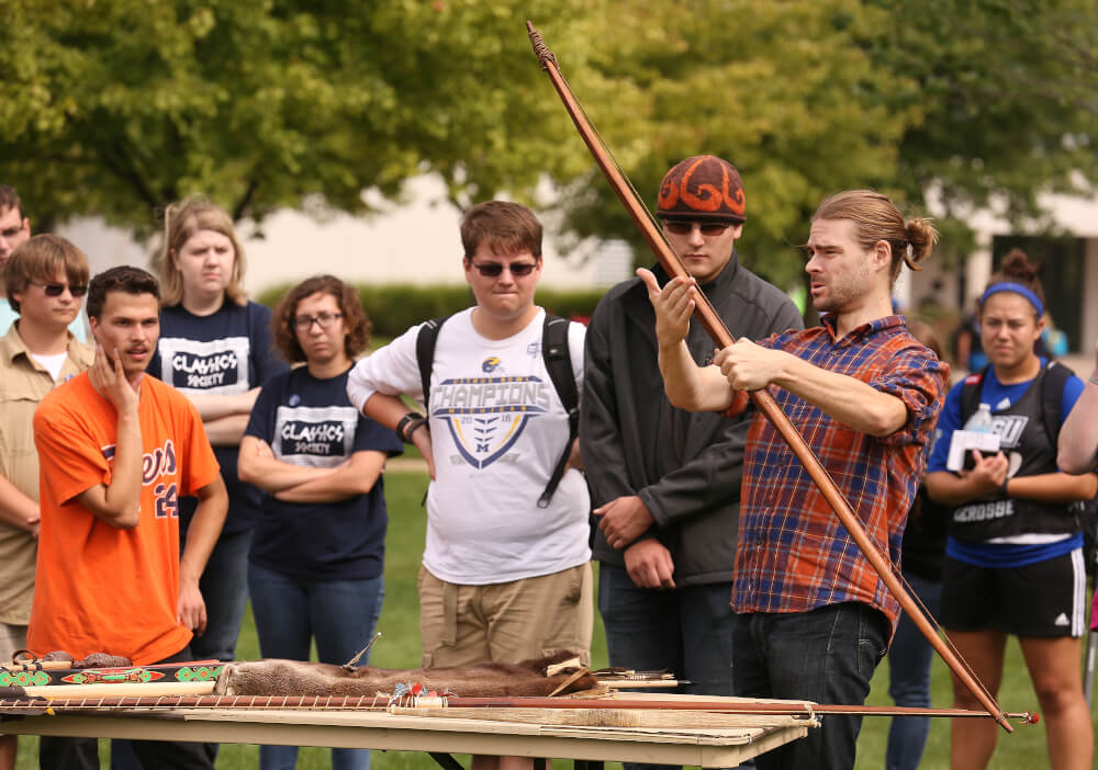 Students learning about archery from Christopher Schaffer, assistant professor of anthropology. Photo by Rex Larsen