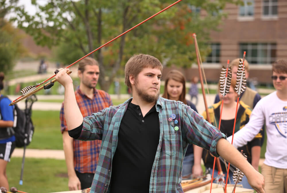 Students learning about ancient weaponry. Photo by Rex Larsen