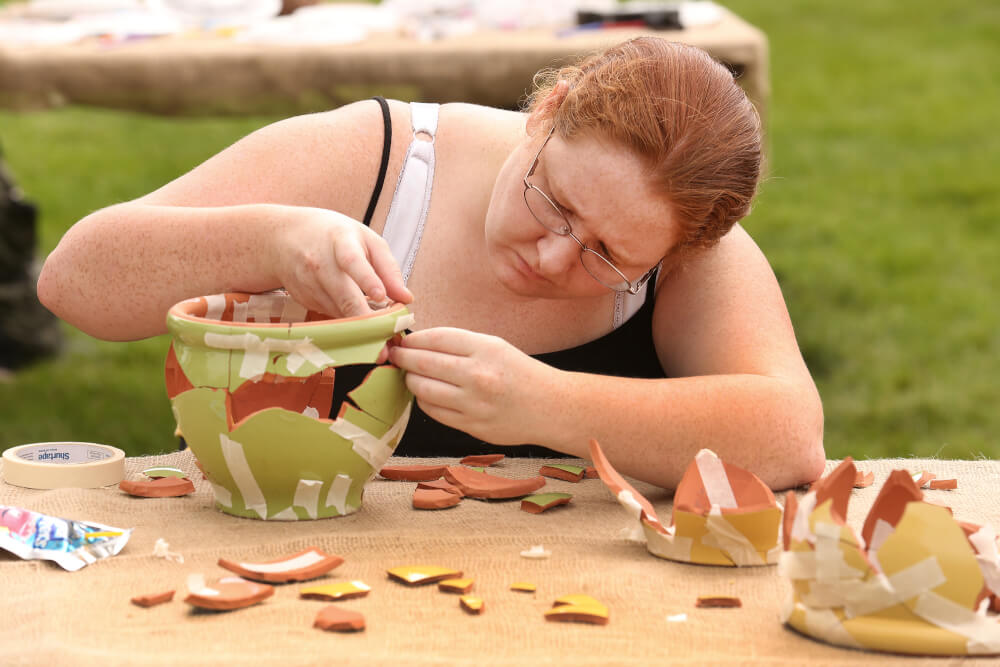 Students assembling ancient pottery. Photo by Rex Larsen