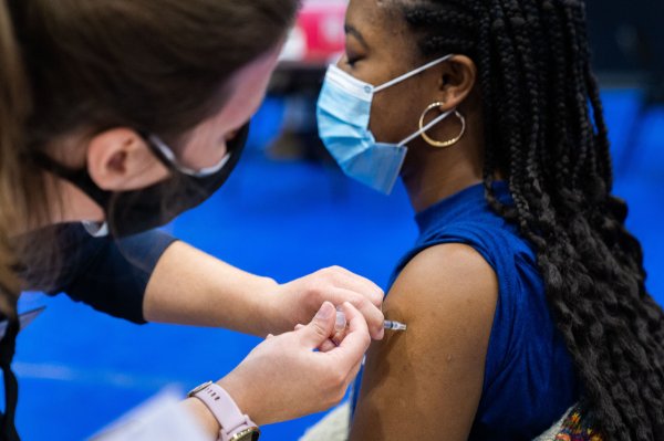 A student receives a COVID-19 vaccine.