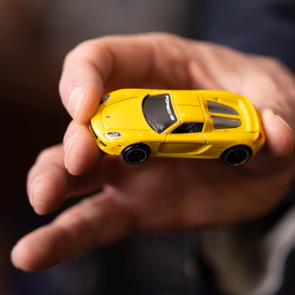 hand holding toy car