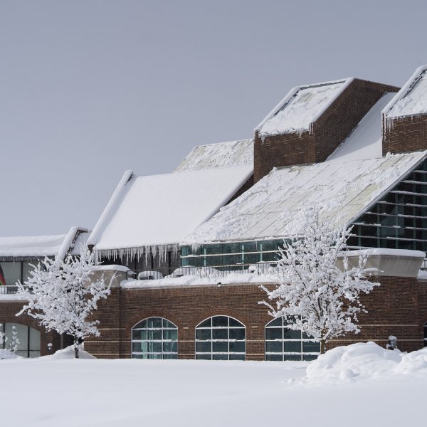winter photo of Kirkhof Center with snow on ground and roof, ice
