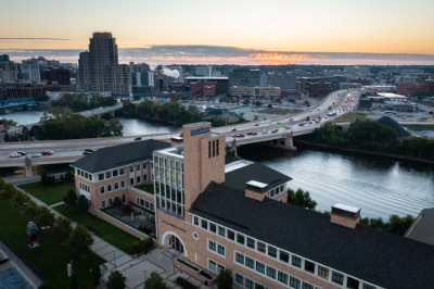 Drone shot of sunrise behind Seidman College of Business building