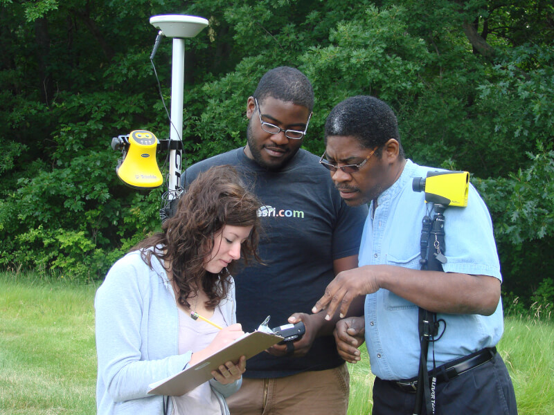 3 people standing outside