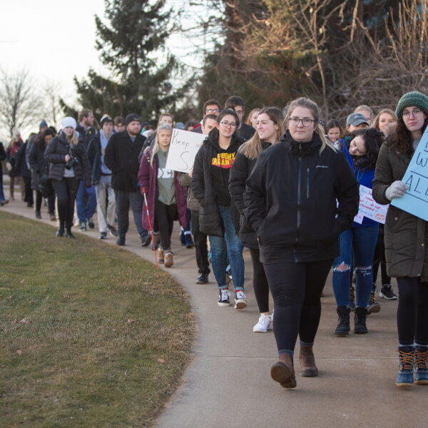 two women leading a march