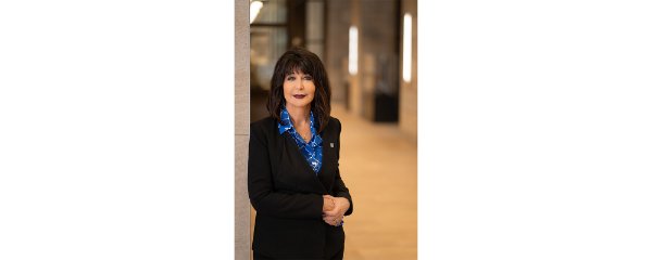 Philomena V. Mantella leans against a wall for a portrait.