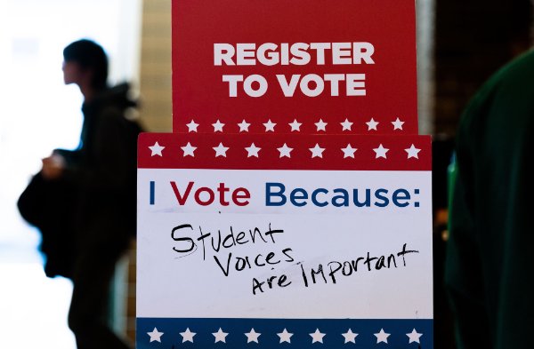 A sign that reads "Register to vote: I vote because", with "student voices are important" written below. 