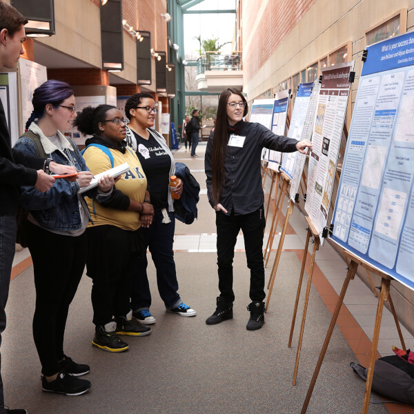 group of people looking at a poster
