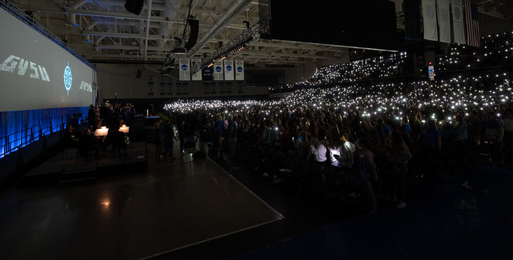 audience with phones lit in Fieldhouse