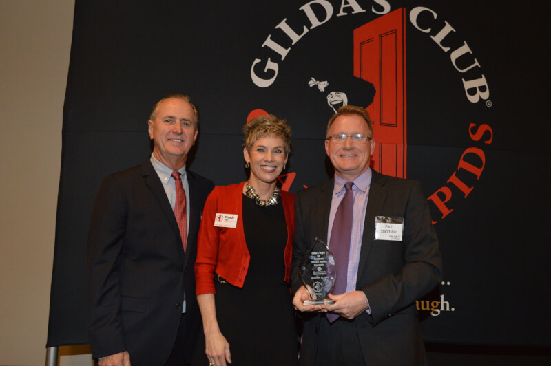  At right, Paul Stansbie, associate dean of the College of Community and Public Service, accepts a service award from Gilda's Club Grand Rapids. He is pictured with Wendy Wigger and Michael Bohnsack, Gilda's Club president and board member, respectively.