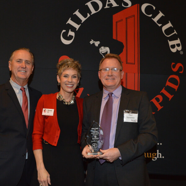  At right, Paul Stansbie, associate dean of the College of Community and Public Service, accepts a service award from Gilda's Club Grand Rapids. He is pictured with Wendy Wigger and Michael Bohnsack, Gilda's Club president and board member, respectively.
