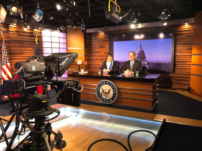 President-elect Philomena Mantella, left, sits with U.S. Sen. Gary Peters during a media availability in Washington D.C.  The two are seated at a desk in a television studio in the U.S. Senate offices. 