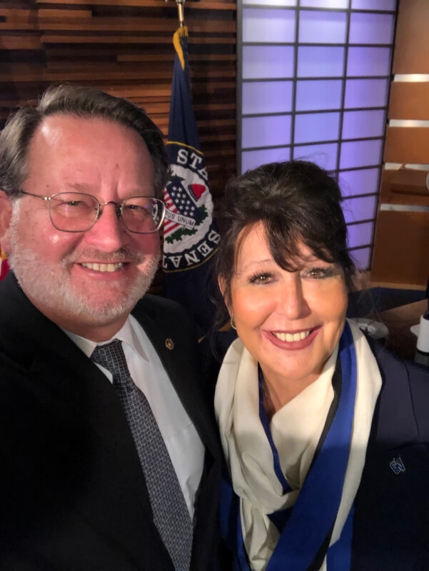 Sen. Gary Peters, left, and President-elect Philomena Mantella, right, pose for a photograph.