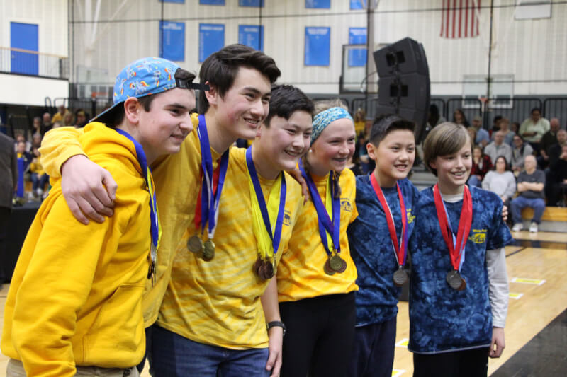 Grand Haven High School and White Pines Intermediate School students showing off their medals.