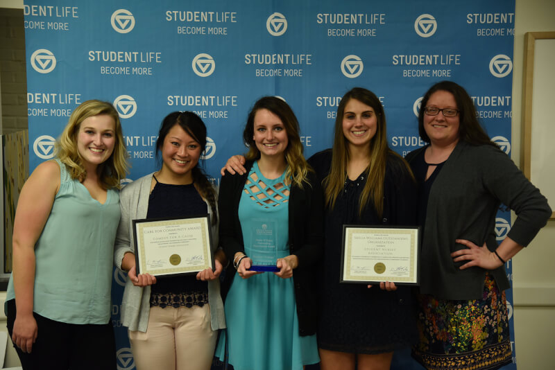 five women holding certificates