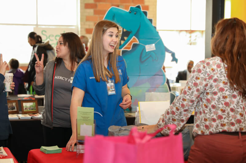 nursing student laughing with health screening participant