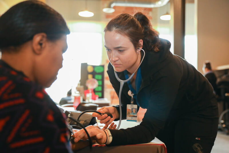 nursing student taking blood pressure reading