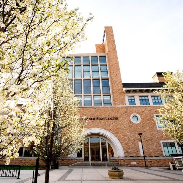 Exterior of the L. William Seidman Center, home of the Seidman College of Business, during a spring day.
