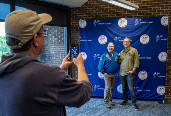 Retired U.S. Navy Commander and former NASA astronaut John Herrington, center, poses for pictures at the Kirkhof Center with Justin Pettibone after speaking about the importance of democracy as part of Astronauts for America on the Valley Campus on September 15.