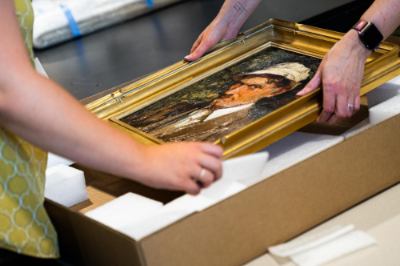 Workers pack a Mathias Alten painting.