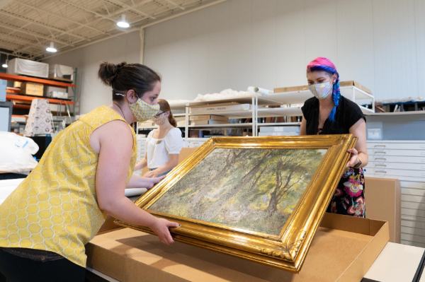 Employees pack a Mathias Alten painting.