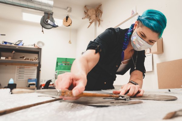 Work is done on a mounting for artifacts.