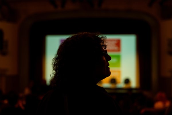 Suzanne Zack speaks with Adam, cinematographer of Three Divided by Zero, during the Summer Film Project&#8217;s 30th anniversary celebration at Wealthy Theatre.