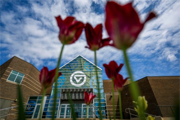Tulips and a blue sky surround the Kirkhof Center on the Valley Campus. 