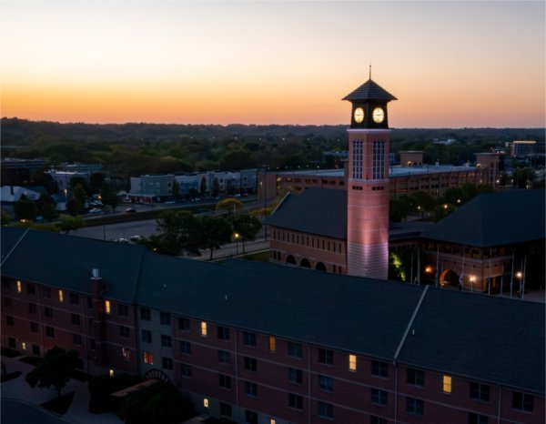 A carillon tower is seen from a drone at sunset. 
