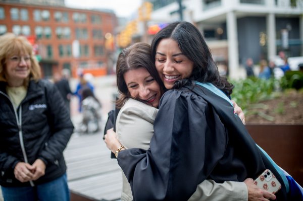  Two people hug after graduation.