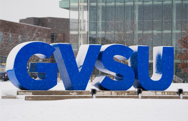  Large blue letters that spell GVSU get covered in the snowfall. 