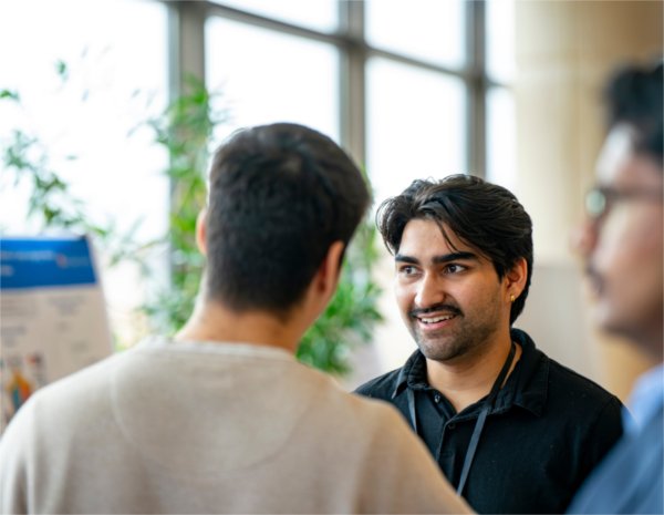 Students laugh in conversation during the project presentation at the College of Computing's Innovation Day.