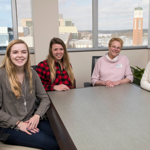 Lynn Blue, vice president for Enrollment Development is pictured with three students.