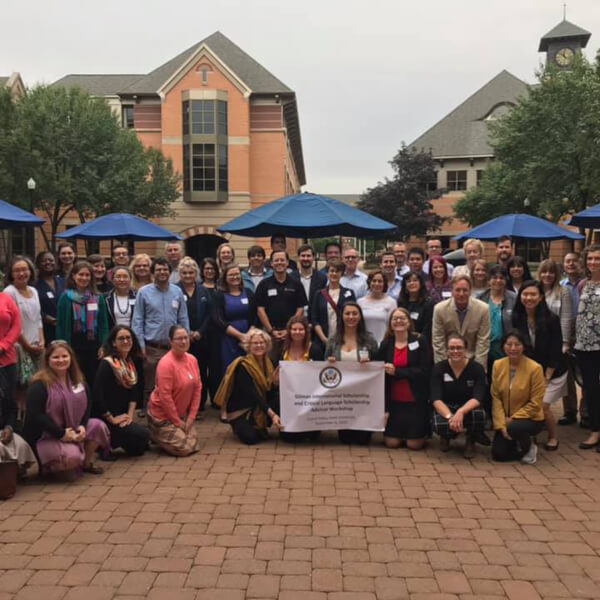 A group of people who took part in the Gilman/CLS scholarship workshop post in the DeVos Center Courtyard for a group photo.