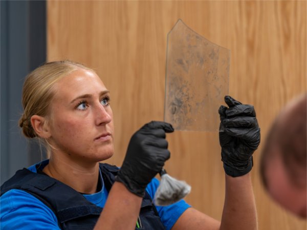 GVSU Police Academy Recruit analyzes evidence during a forensic recovery training,