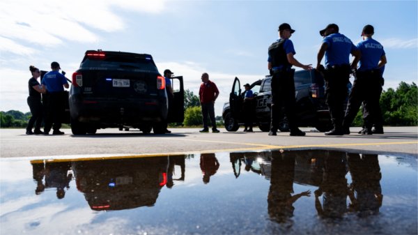 Police Academy recruits stand by cars during traffic stop training