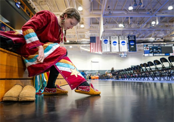Ellie Myers, of the Sault Ste. Marie Tribe, prepares her regalia before the Pow Wow.