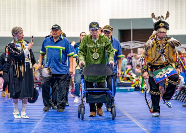 Air Force veteran George Martin, 90, center, of the Match-E-Be-Nash-She-Wish Band of Pottawatomi, is honored with a dance during the All Walks of Life Traditional Powwow at the Fieldhouse on April 4.