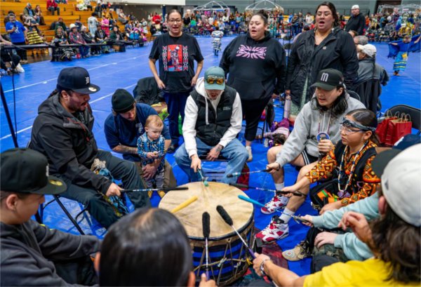 Members of the Woodland Stream powwow group perform on a drum during the All Walks of Life Traditional Powwow at the Fieldhouse on April 4.