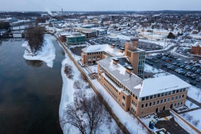 aerial view, snowy, of Seidman Center next to Grand River.